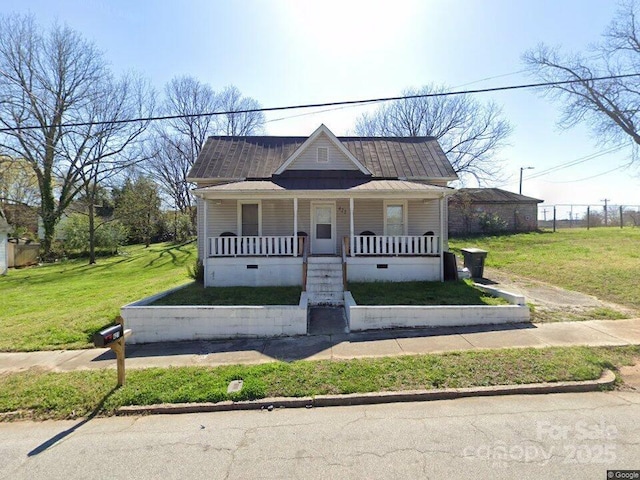 bungalow-style home with crawl space, covered porch, and a front yard