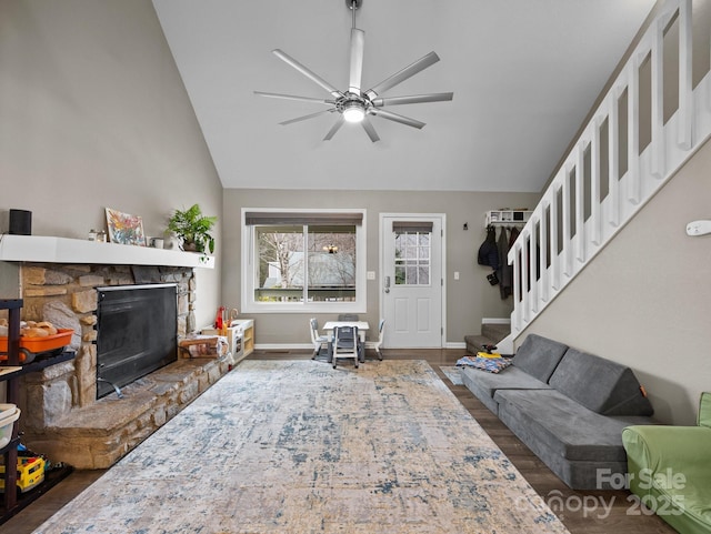 living room with stairway, a fireplace, dark wood-style flooring, and baseboards