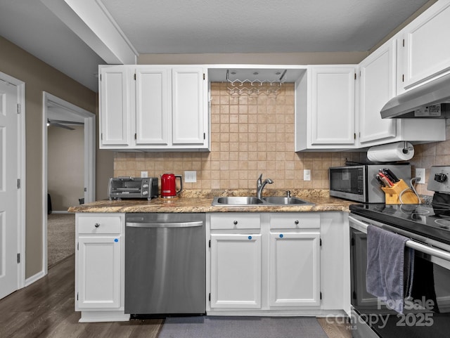 kitchen featuring white cabinets, appliances with stainless steel finishes, and a sink