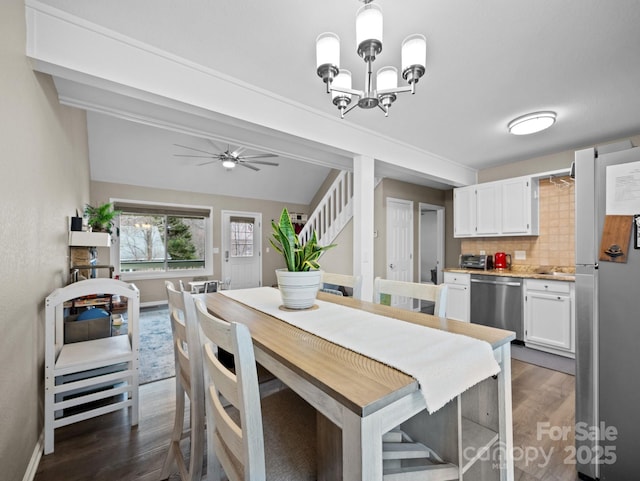 dining area with dark wood-style floors, ceiling fan with notable chandelier, stairs, and baseboards