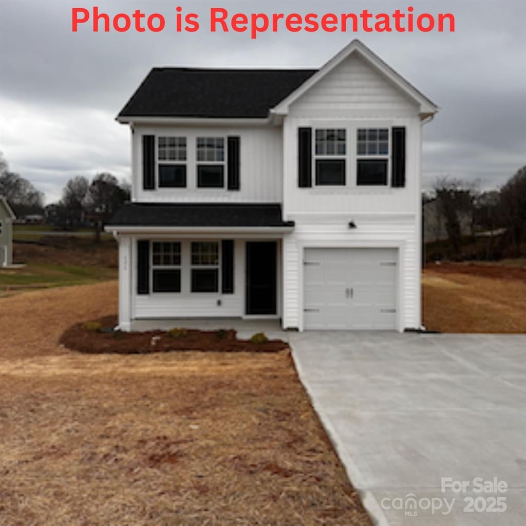 traditional home featuring a garage and concrete driveway