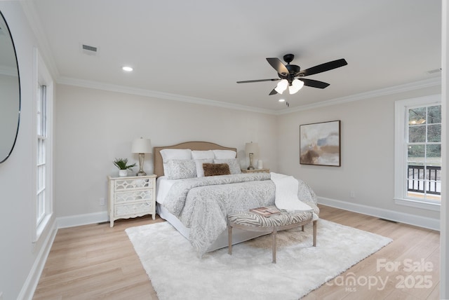 bedroom with light wood-type flooring, visible vents, crown molding, and baseboards