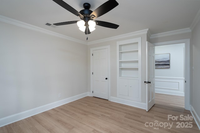 unfurnished bedroom with light wood-style floors, visible vents, and ornamental molding