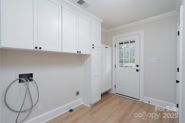 washroom featuring hookup for a washing machine, visible vents, ornamental molding, cabinet space, and light wood finished floors