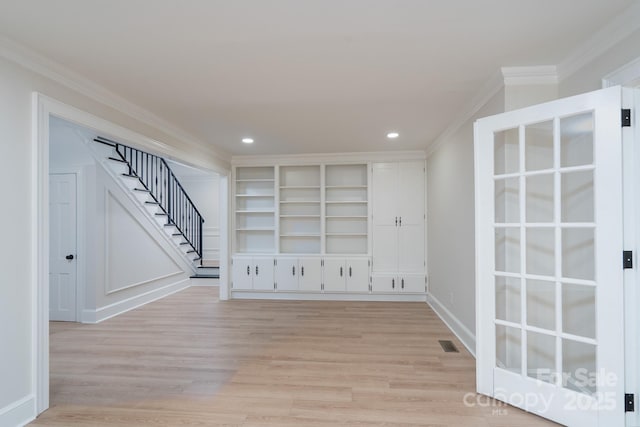 spare room featuring light wood-style flooring, recessed lighting, visible vents, stairs, and ornamental molding