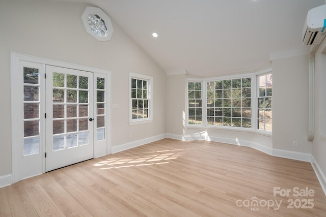 unfurnished sunroom featuring lofted ceiling and a wall mounted air conditioner