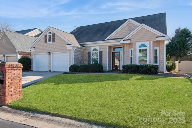 view of front of house with concrete driveway, a front lawn, roof with shingles, and fence