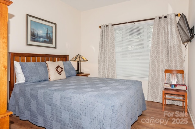 bedroom featuring wood finished floors