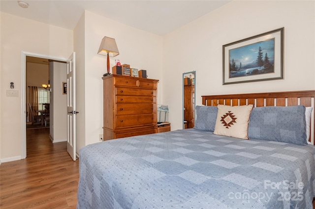 bedroom with wood finished floors and baseboards