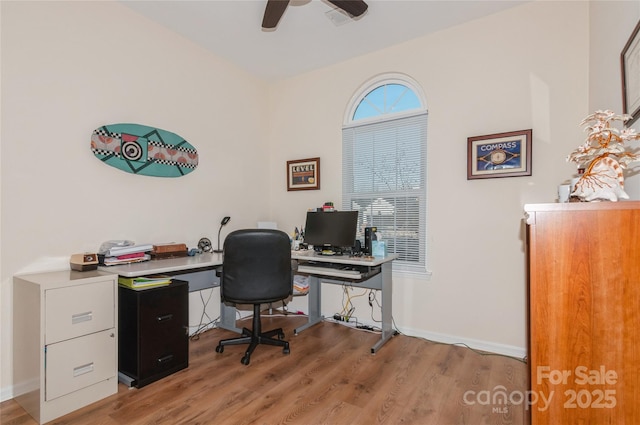 office area featuring baseboards, ceiling fan, and light wood finished floors