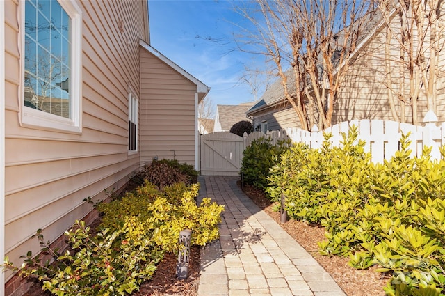 view of home's exterior featuring fence and a gate