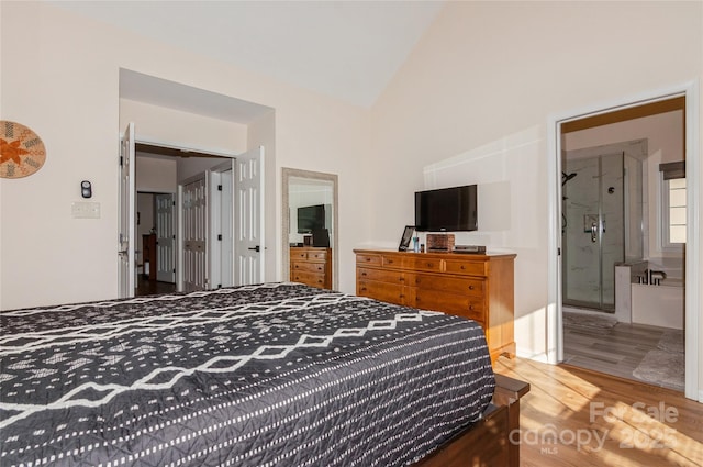 bedroom with lofted ceiling and wood finished floors