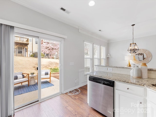 kitchen with crown molding, visible vents, light wood-style flooring, white cabinetry, and dishwasher