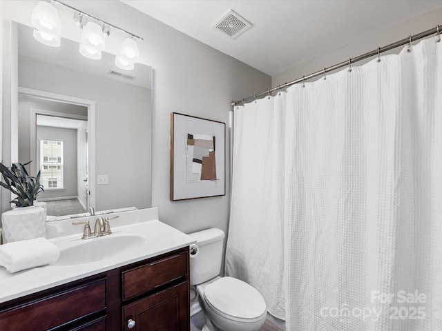 full bathroom featuring visible vents, vanity, and toilet