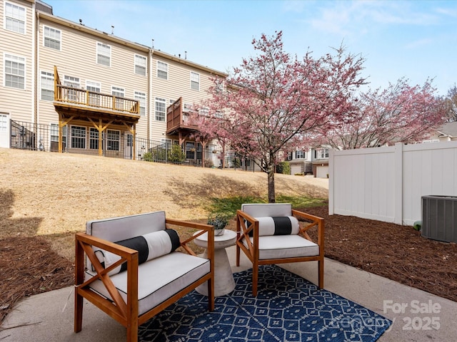 view of patio / terrace with fence and central air condition unit