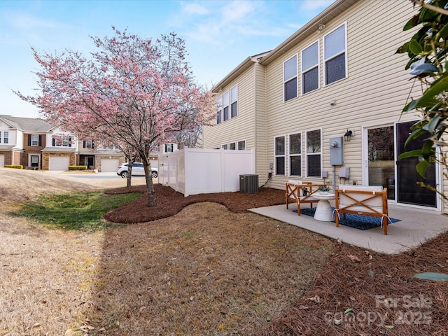 rear view of property with a patio, cooling unit, and fence