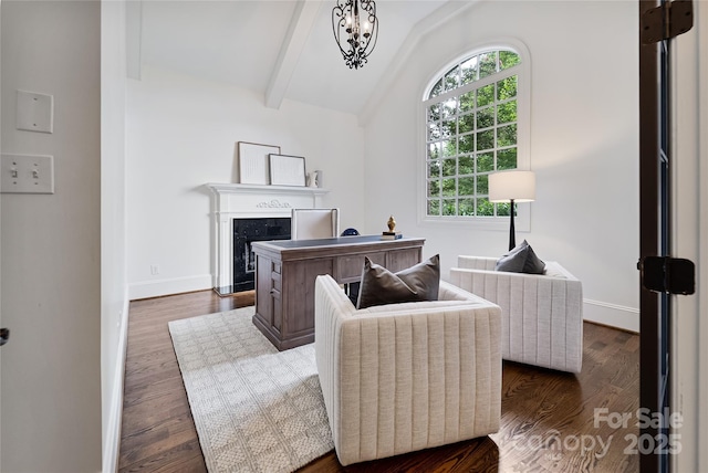 office area with lofted ceiling with beams, dark wood-style floors, a high end fireplace, and baseboards