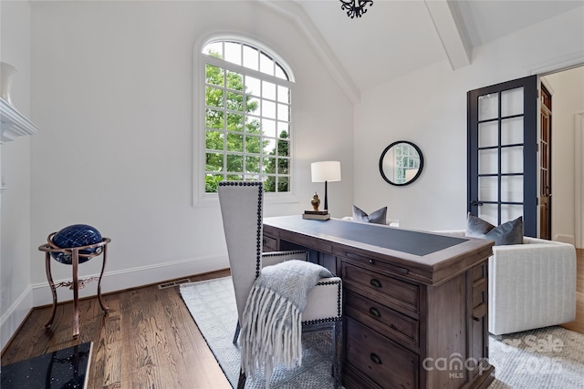 home office featuring lofted ceiling with beams, wood finished floors, visible vents, and baseboards