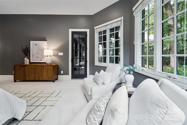 carpeted bedroom with access to outside and baseboards