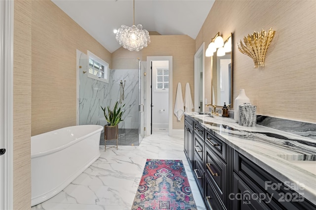 full bathroom with a freestanding bath, marble finish floor, vaulted ceiling, a marble finish shower, and double vanity