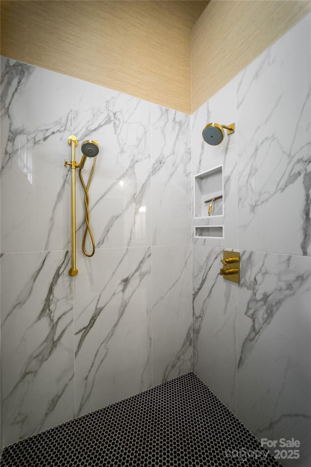 full bath featuring a marble finish shower