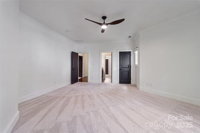 interior space with visible vents, baseboards, a ceiling fan, crown molding, and carpet flooring