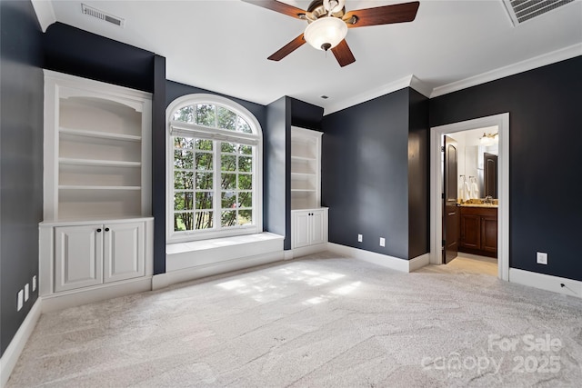 unfurnished bedroom featuring carpet, visible vents, crown molding, and baseboards