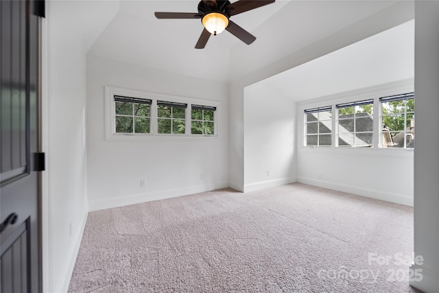 unfurnished room featuring carpet, a healthy amount of sunlight, and baseboards