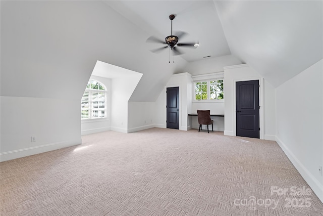 bonus room with light carpet, lofted ceiling, and baseboards