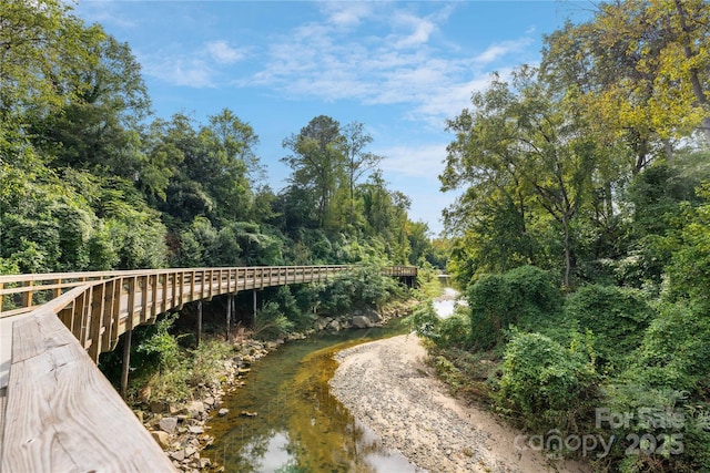 surrounding community featuring a wooded view