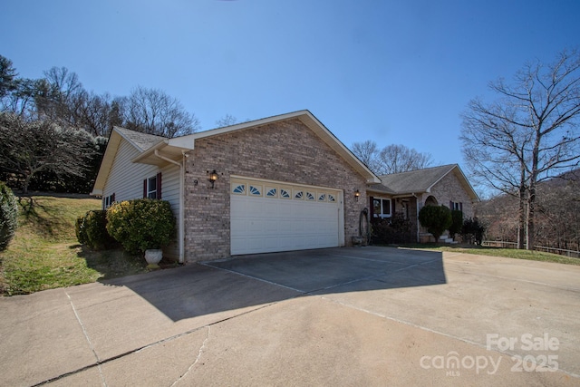 ranch-style house with driveway, brick siding, and an attached garage