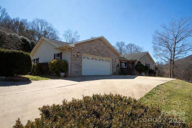 view of front of house with concrete driveway, brick siding, and an attached garage