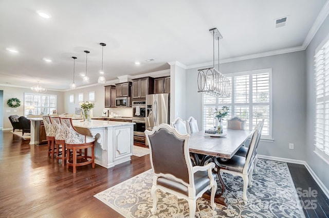 dining space with a notable chandelier, dark wood-style floors, visible vents, and ornamental molding