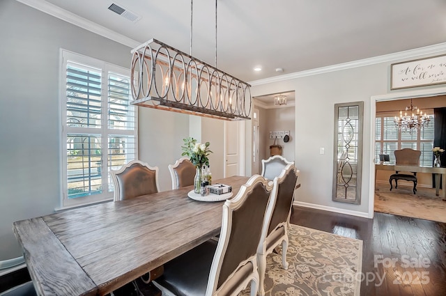 dining space featuring visible vents, crown molding, baseboards, dark wood-type flooring, and an inviting chandelier