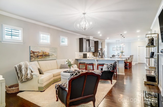 living area with baseboards, recessed lighting, dark wood-style flooring, crown molding, and a chandelier