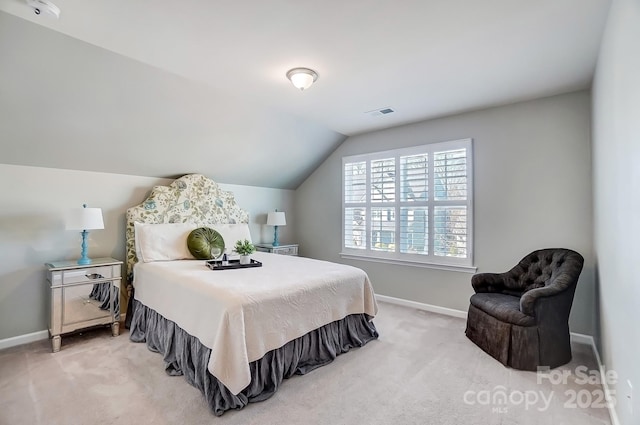 bedroom with lofted ceiling, visible vents, baseboards, and light carpet