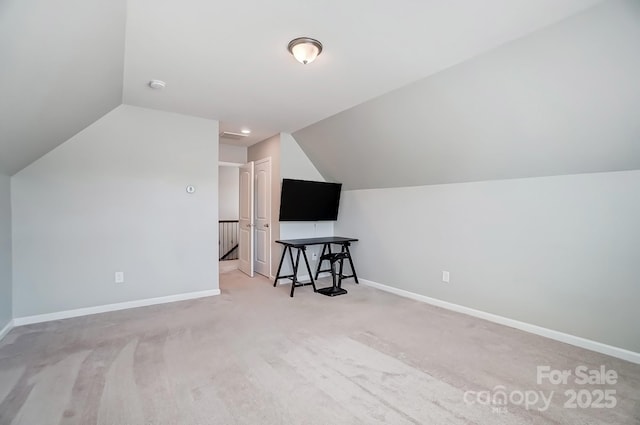 additional living space featuring carpet flooring, lofted ceiling, and baseboards