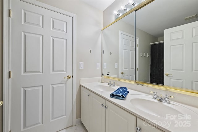 bathroom featuring double vanity, a sink, visible vents, and tile patterned floors