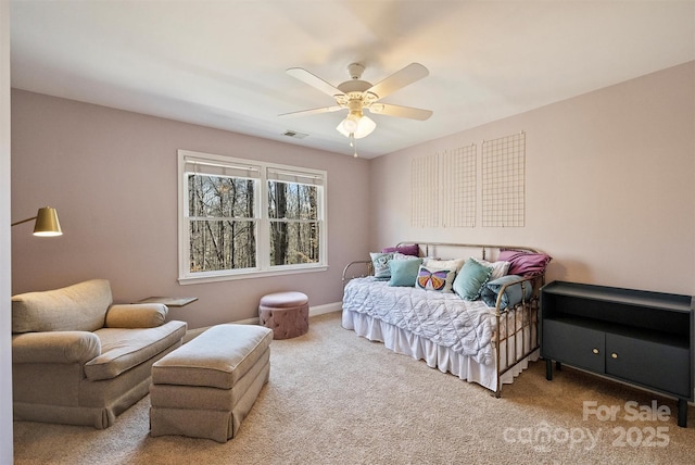 carpeted bedroom featuring ceiling fan, visible vents, and baseboards