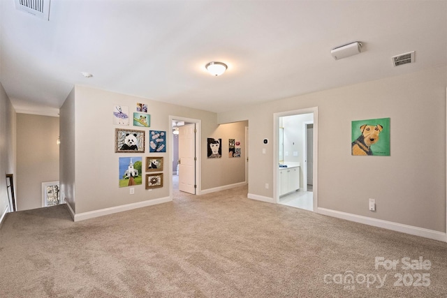 interior space with light carpet, baseboards, and visible vents