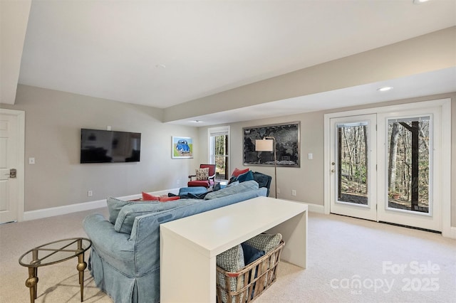 living room with light colored carpet and baseboards