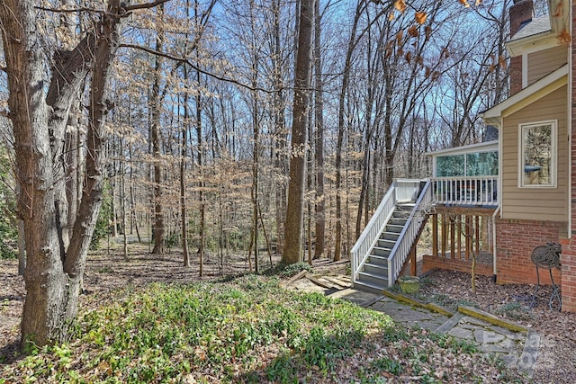 view of yard featuring stairs and a deck