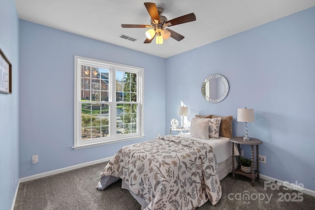 carpeted bedroom featuring baseboards, visible vents, and ceiling fan