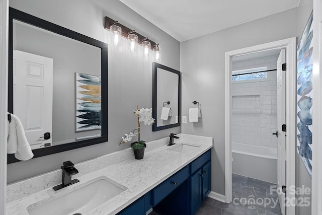 full bathroom featuring bathtub / shower combination, a sink, and double vanity