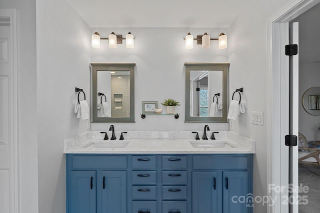 full bathroom with double vanity and a sink