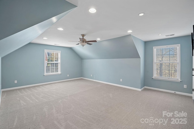 bonus room featuring carpet floors, visible vents, baseboards, and a ceiling fan