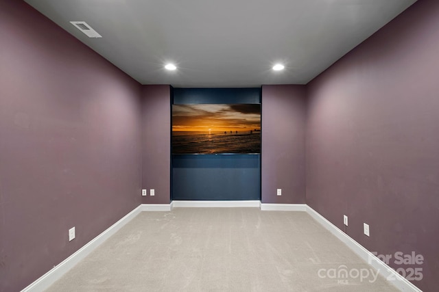 empty room with carpet floors, recessed lighting, visible vents, and baseboards