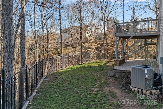 view of yard with cooling unit, a fenced backyard, a deck, and stairs