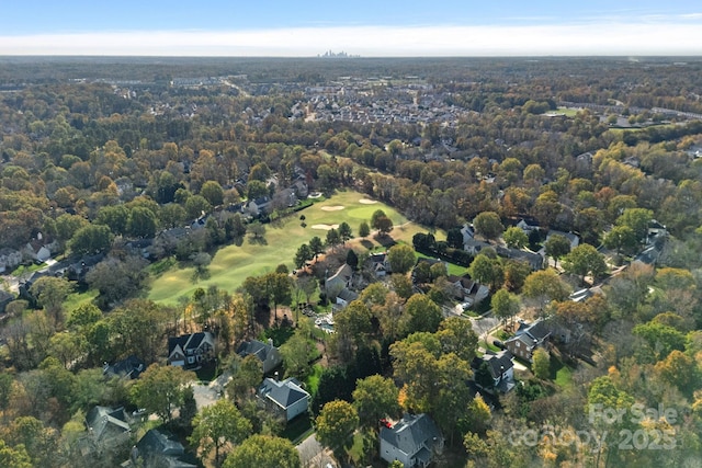 drone / aerial view featuring a view of trees