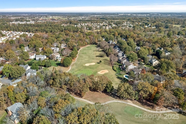 aerial view with view of golf course and a view of trees